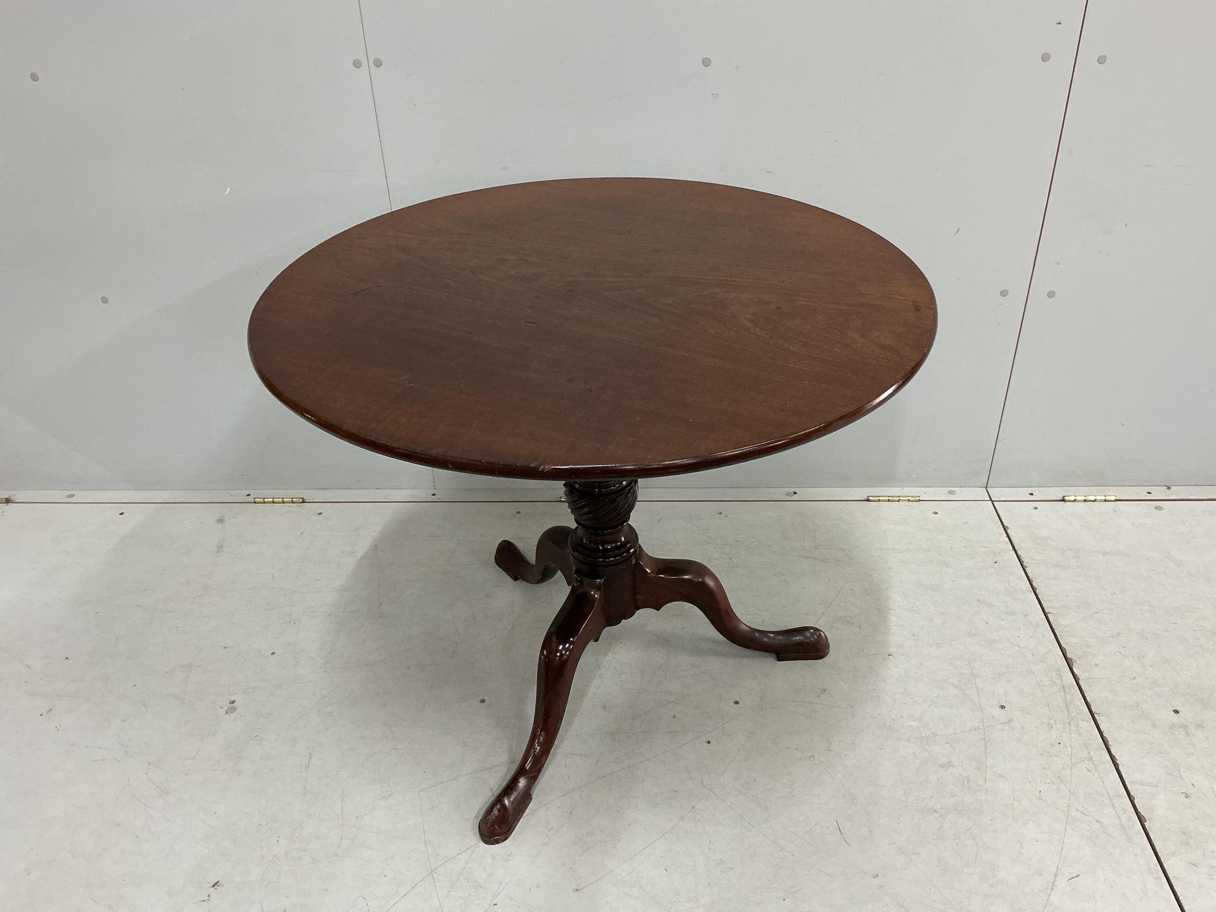 A George III circular mahogany tilt top tripod tea table, diameter 91cm, height 72cm